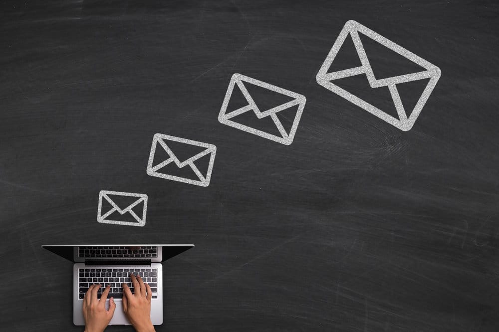 Picture of somebody answering emails - accompanies article about Mailchimp's new single opt-in process.