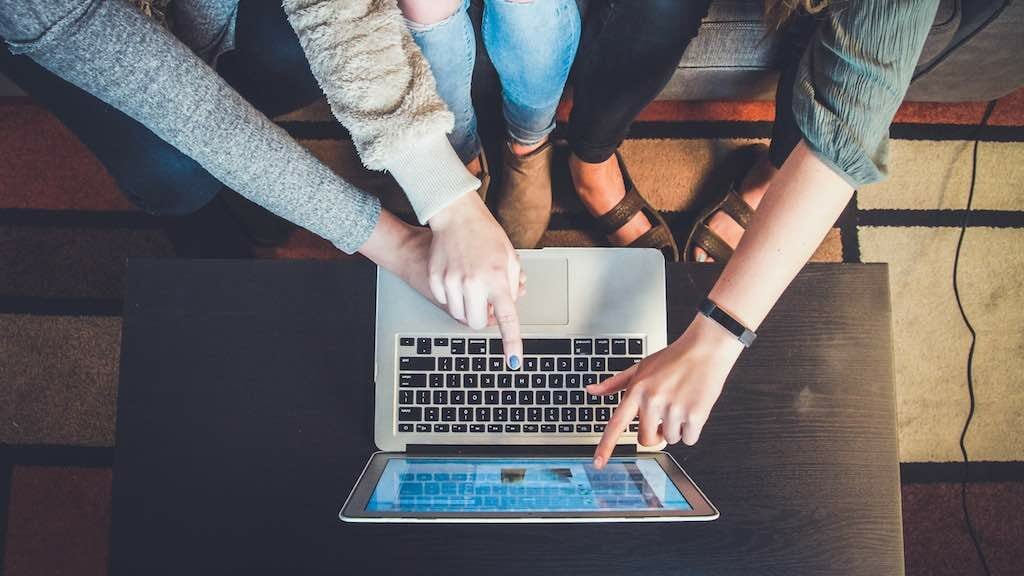 Attacting customers to an online store (image of people gathered around a laptop).