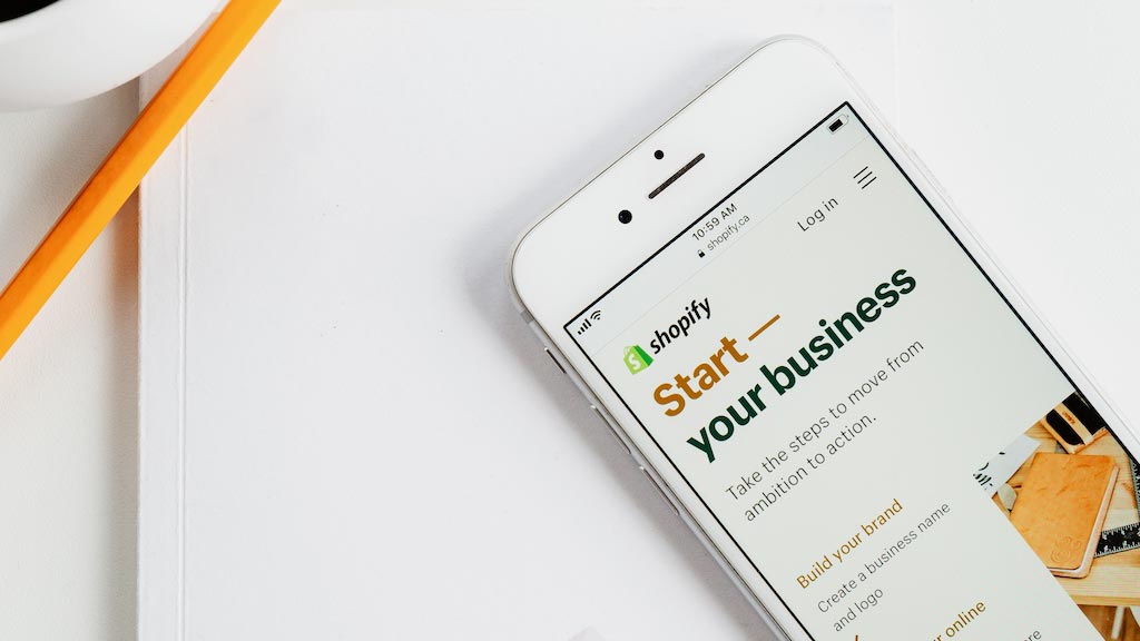 How to start a Shopify store — picture of a mobile phone displaying the Shopify website.