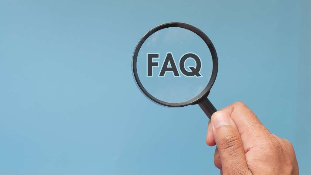 Google reduces visibility of FAQ and HowTo snippets in search results — image of FAQ text in a magnifying glass.