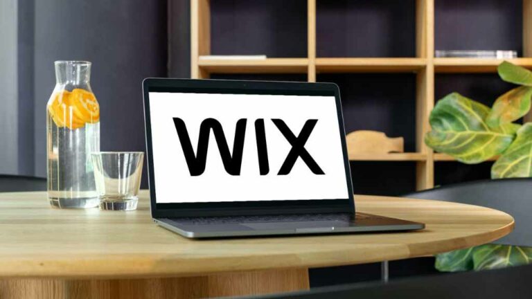 'Wix Q2 2023 results exceed expectations' - the Wix logo on a laptop computer.